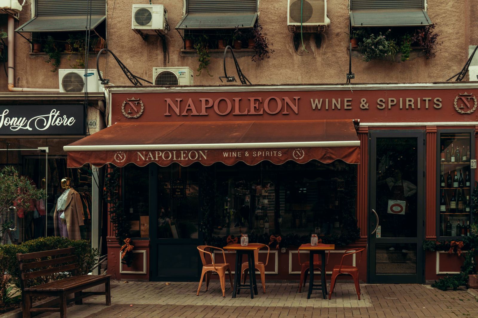 Cozy view of an outdoor cafe in Tirana with tables and urban decor.